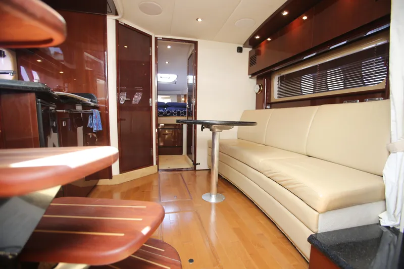 Slide: The Image of Interior of 2010 Sea Ray 390 Sundancer yacht with beige seating and wooden finishes. - 17