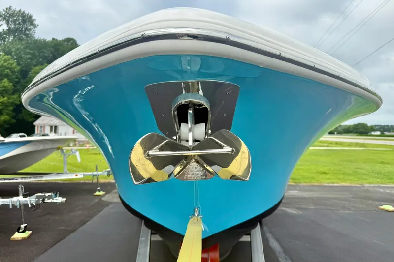 Slide: The Image of 2025 Key West 291 FS boat with blue hull and shiny anchor on trailer. - 10