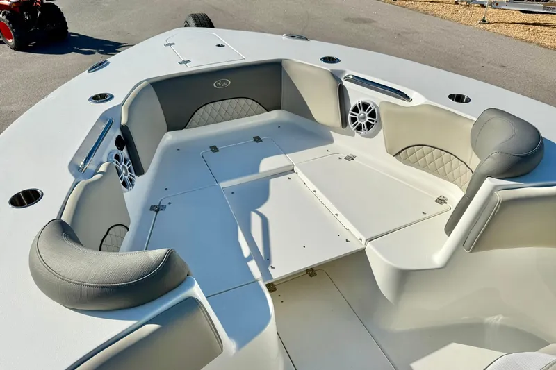 Slide: The Image of 2025 Key West 291 FS boat interior with cushioned seating and built-in speakers. - 18