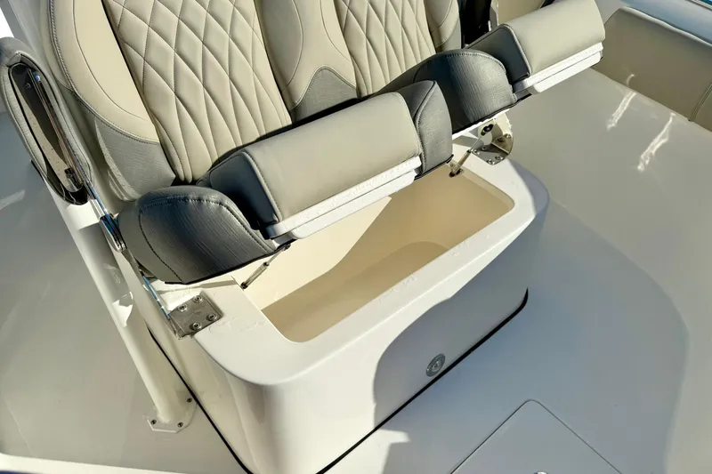 Slide: The Image of 2025 Key West 291 FS boat seat with storage compartment open. - 24
