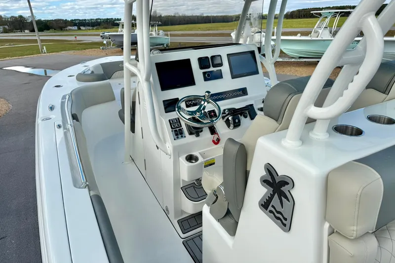 Slide: The Image of 2025 Key West 291 FS boat interior with modern dashboard and seating. - 25
