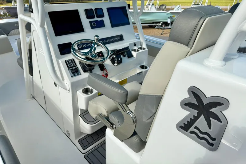 Slide: The Image of 2025 Key West 291 FS boat cockpit with modern controls and palm tree logo. - 27