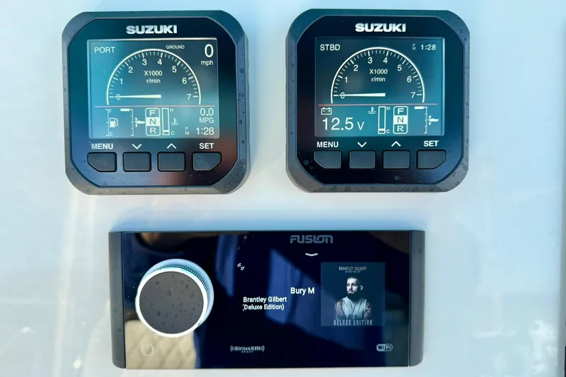 Slide: The Image of Dashboard of a 2025 Key West 291 FS boat with Suzuki displays and Fusion audio system. - 37