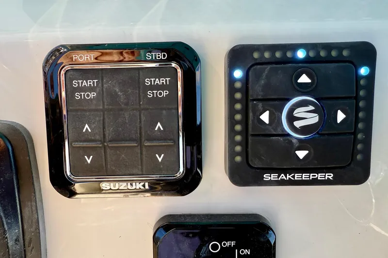 Slide: The Image of Control panel of a 2025 Key West 291 FS boat with Suzuki and Seakeeper systems. - 38