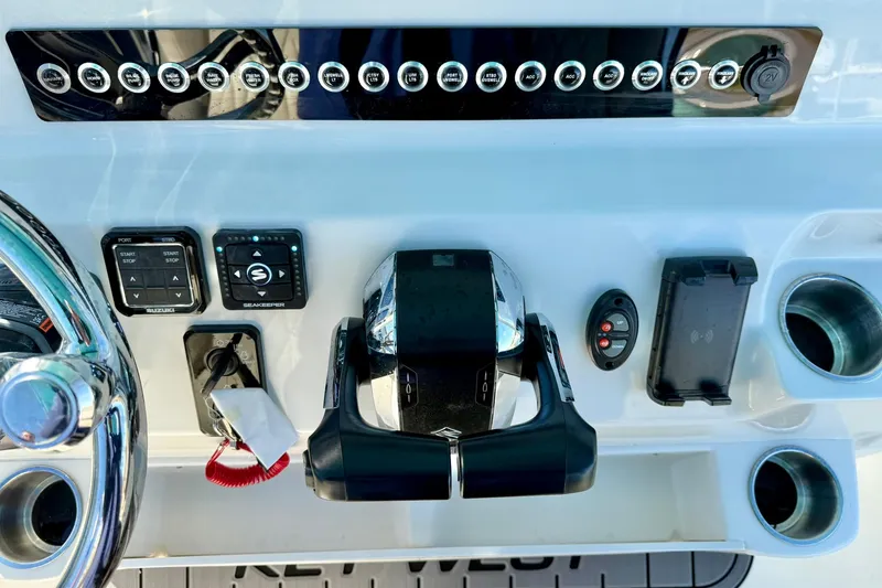 Slide: The Image of Control panel of 2025 Key West 291 FS boat with steering wheel and switches. - 39