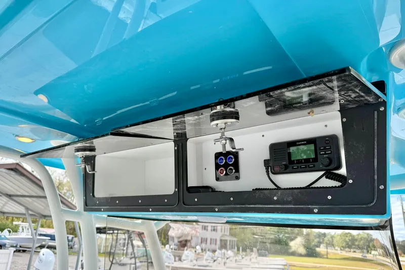 Slide: The Image of 2025 Key West 291 FS boat console with electronic controls and storage compartments. - 41