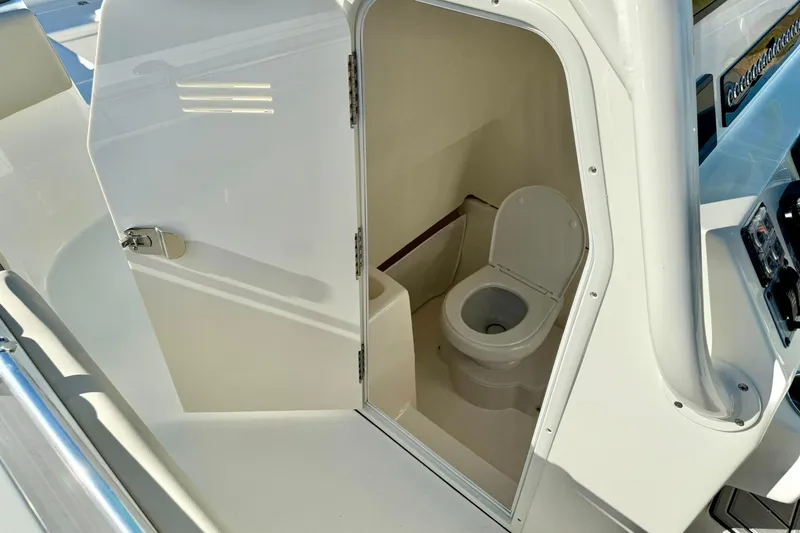 Slide: The Image of 2025 Key West 291 FS boat interior with compact marine toilet. - 43