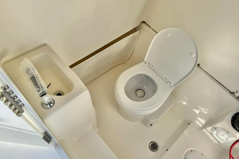 Slide: The Image of 2025 Key West 291 FS boat bathroom with toilet and compact sink. - 44