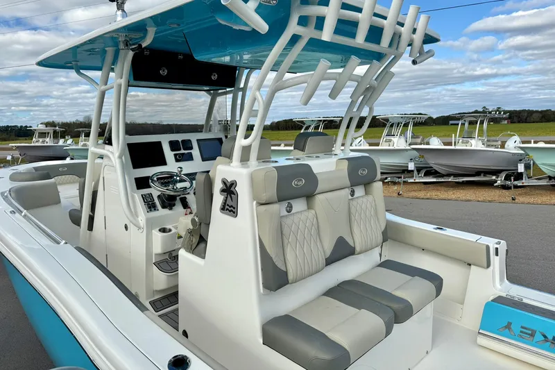 Slide: The Image of 2025 Key West 291 FS boat interior with seating and helm, displayed outdoors. - 48