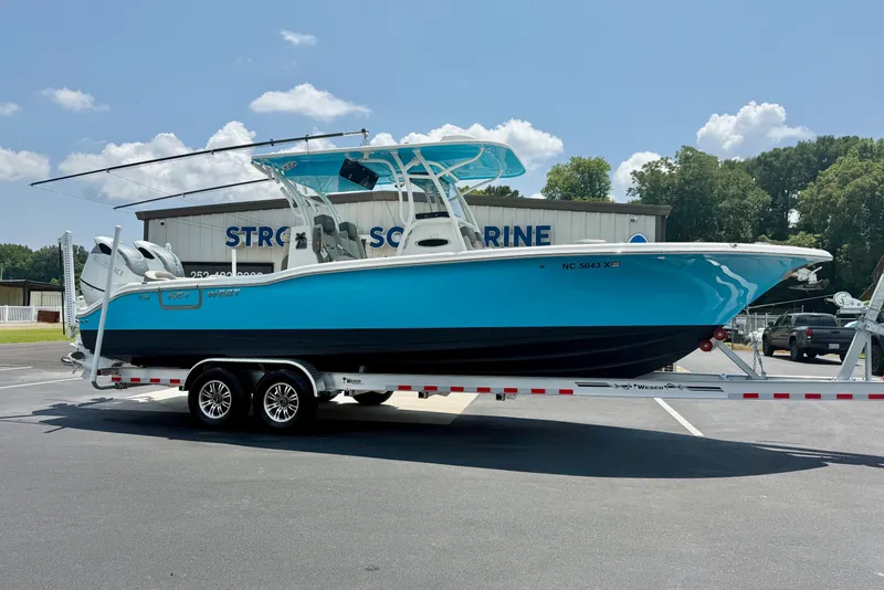 Slide: The Image of 2025 Key West 291 FS boat on trailer, parked outside marine dealership. - 7