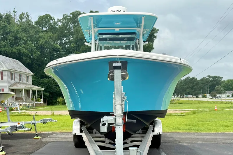 Slide: The Image of 2025 Key West 291 FS boat on trailer, vibrant blue hull, parked outdoors. - 8