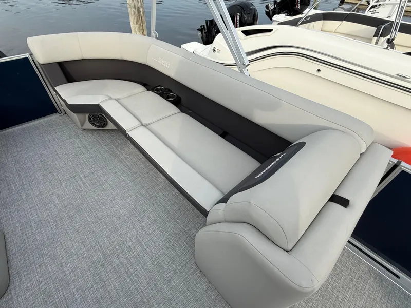 Slide: The Image of 2024 Harris Cruiser 230 boat interior with spacious seating and modern design. - 10