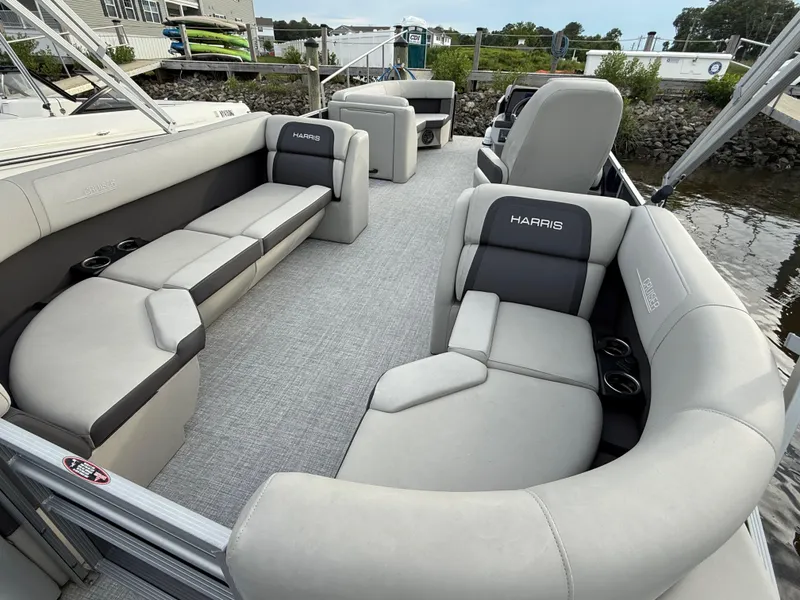 Slide: The Image of 2024 Harris Cruiser 230 pontoon boat interior with plush seating and cup holders. - 12