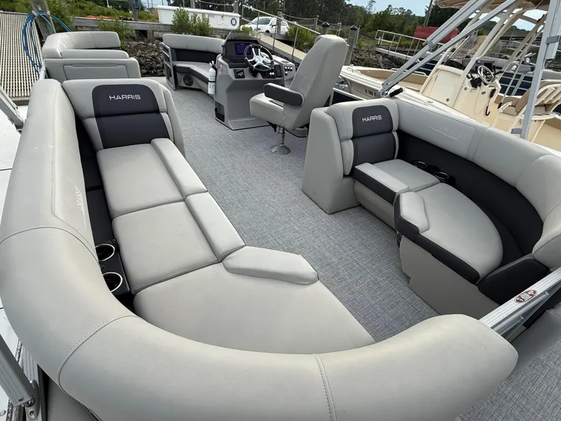 Slide: The Image of 2024 Harris Cruiser 230 pontoon boat interior with plush seating and modern helm. - 13
