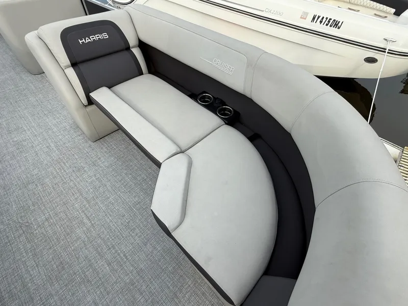 Slide: The Image of 2024 Harris Cruiser 230 boat interior with gray seating and cup holders. - 15