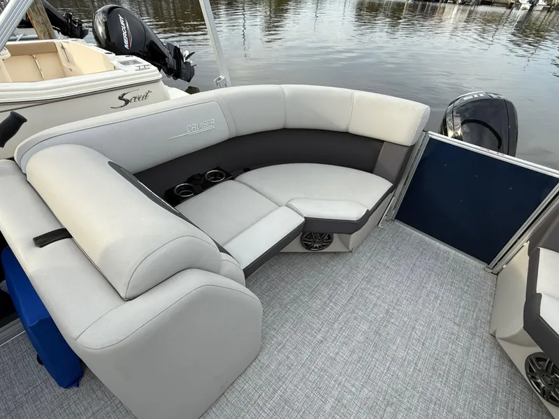 Slide: The Image of 2024 Harris Cruiser 230 pontoon boat interior with plush seating and cup holders. - 9