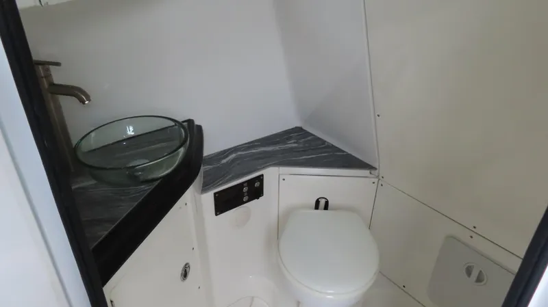 Slide: The Image of Modern boat bathroom with glass sink, sleek faucet, and compact toilet in MTI 50v, 2022 model. - 12