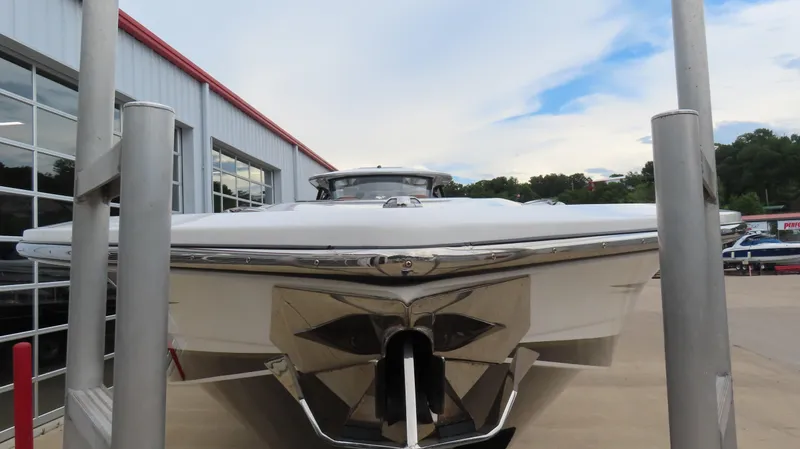 Slide: The Image of 2022 MTI 50v boat front view at a marina, showcasing sleek design and modern features. - 2