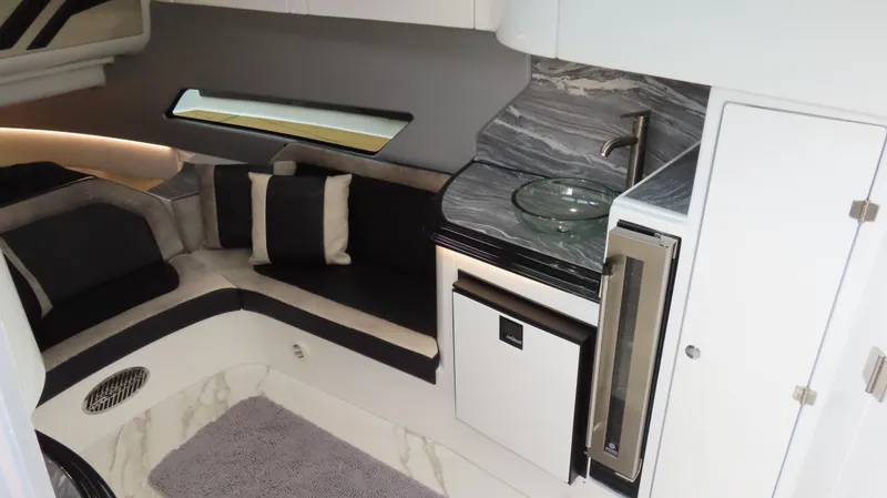 Slide: The Image of Luxurious MTI 50v 2022 yacht interior with modern kitchenette and cozy seating area. - 39