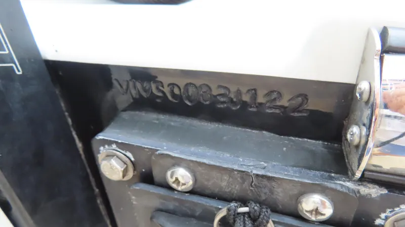 Slide: The Image of Close-up of MTI 50v 2022 model serial number on metal surface. - 42