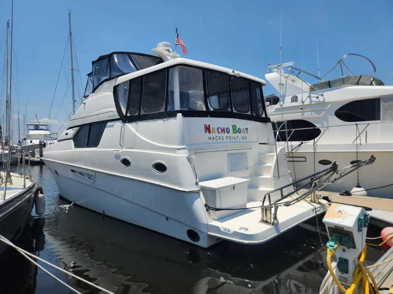 The Image of 2000 Silverton 453 Motor Yacht docked at marina, sunny day, "Nacho Boat" on stern. - 0