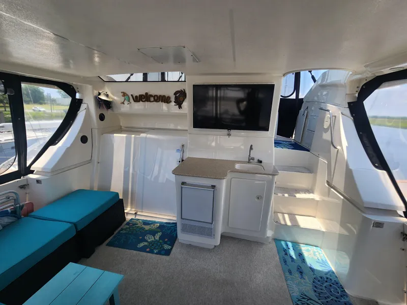 Slide: The Image of Interior of 2000 Silverton 453 Motor Yacht with seating, kitchenette, and TV. - 18