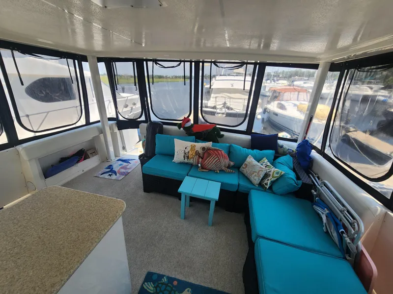 Slide: The Image of Interior of 2000 Silverton 453 Motor Yacht with cozy seating and vibrant decor. - 19