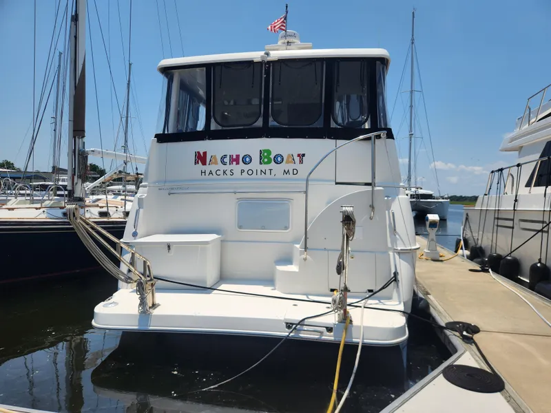 Slide: The Image of 2000 Silverton 453 Motor Yacht docked at marina, labeled "Nacho Boat," Hacks Point, MD. - 2