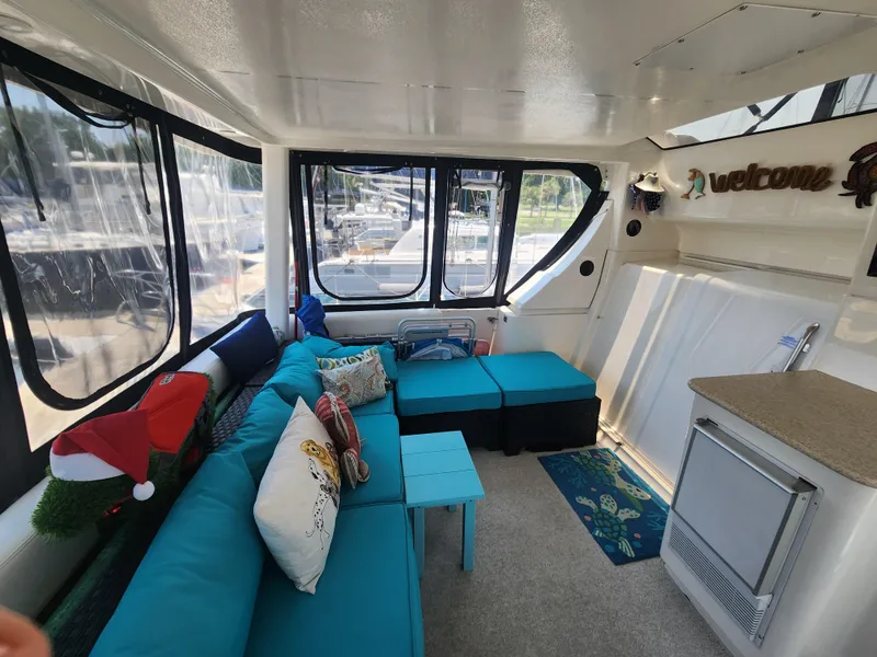 Slide: The Image of Interior of 2000 Silverton 453 Motor Yacht with cozy seating and nautical decor. - 20