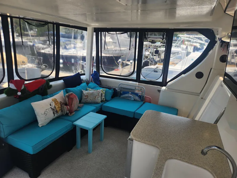 Slide: The Image of Interior of 2000 Silverton 453 Motor Yacht with blue seating and decorative pillows. - 21