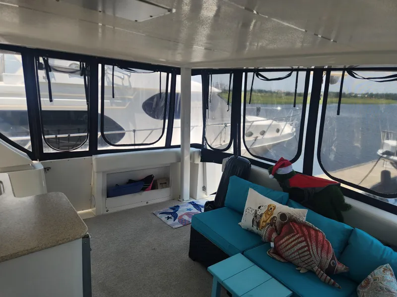 Slide: The Image of Interior of 2000 Silverton 453 Motor Yacht with blue seating and decorative pillows. - 22