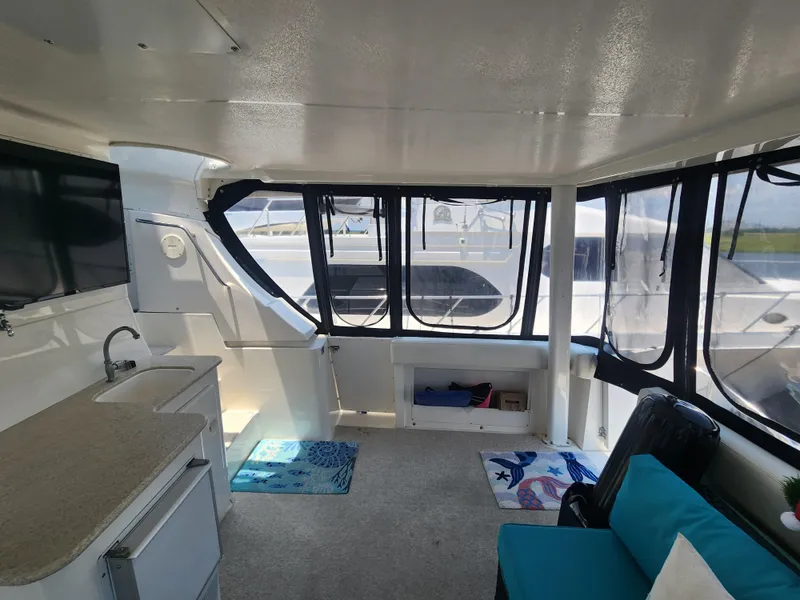 Slide: The Image of Interior of 2000 Silverton 453 Motor Yacht with kitchenette and seating area. - 23