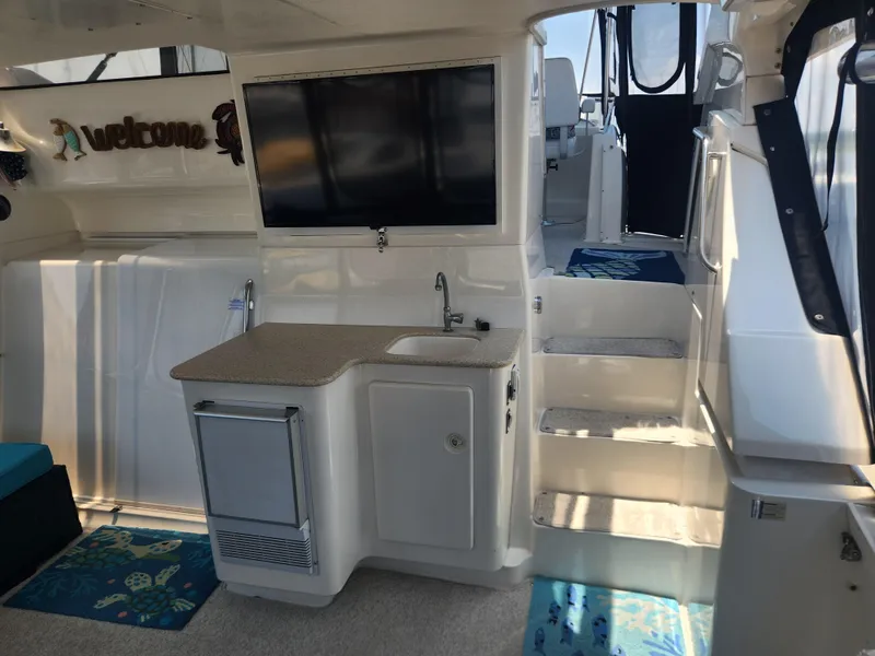 Slide: The Image of Interior of 2000 Silverton 453 Motor Yacht with kitchenette and stairs. - 24