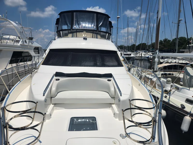 Slide: The Image of 2000 Silverton 453 Motor Yacht docked at marina under clear blue sky. - 28