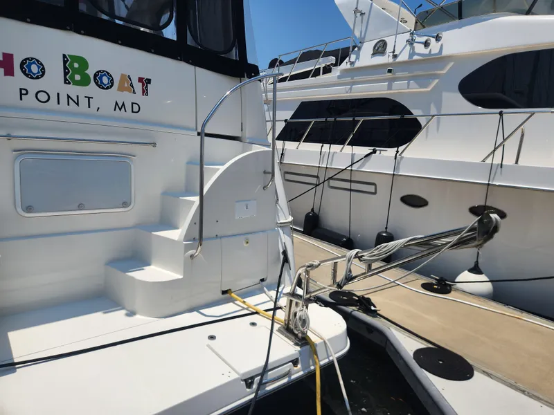 Slide: The Image of 2000 Silverton 453 Motor Yacht docked, featuring steps and railing, Point, MD. - 3