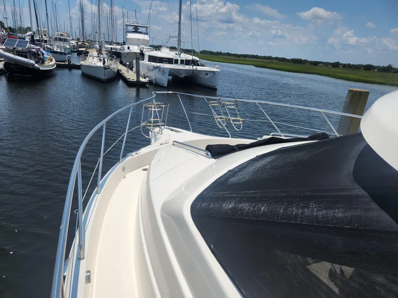 Slide: The Image of 2000 Silverton 453 Motor Yacht docked in a marina under a clear blue sky. - 30