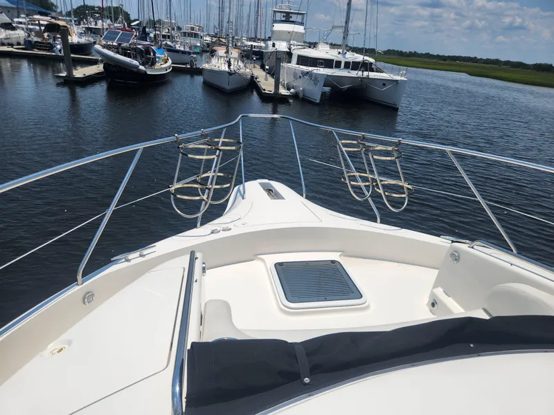 Slide: The Image of 2000 Silverton 453 Motor Yacht docked at marina, surrounded by other boats. - 31
