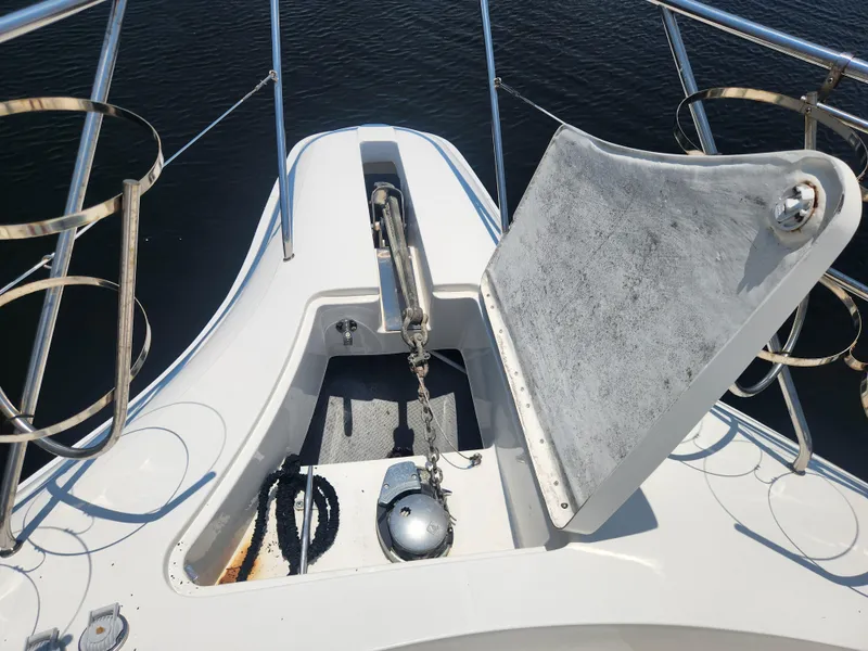 Slide: The Image of 2000 Silverton 453 Motor Yacht anchor compartment with open hatch, showcasing marine equipment. - 33