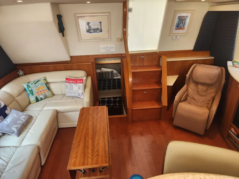 Slide: The Image of Interior of 2000 Silverton 453 Motor Yacht with cozy seating and wooden accents. - 34