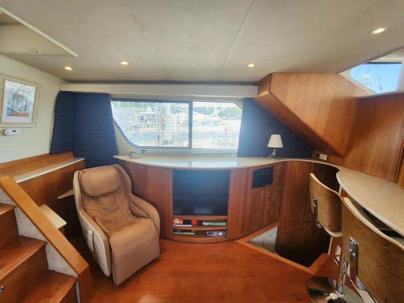 Slide: The Image of Luxurious interior of 2000 Silverton 453 Motor Yacht with cozy seating and nautical decor. - 36