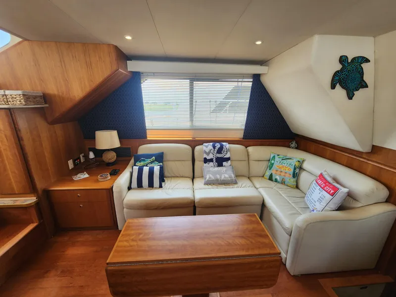 Slide: The Image of Interior of 2000 Silverton 453 Motor Yacht with cozy seating and nautical decor. - 37
