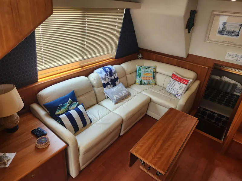 Slide: The Image of Interior of 2000 Silverton 453 Motor Yacht with cozy seating and nautical decor. - 38