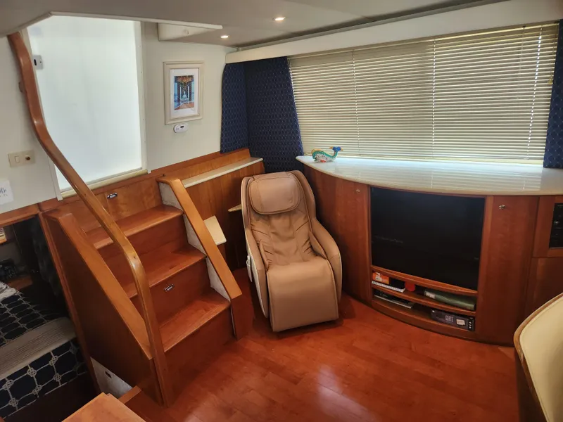 Slide: The Image of Wooden table in a 2000 Silverton 453 Motor Yacht interior, surrounded by a white sofa. - 39