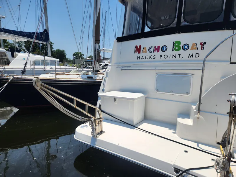 Slide: The Image of 2000 Silverton 453 Motor Yacht docked, featuring "Nacho Boat" from Hacks Point, MD. - 4