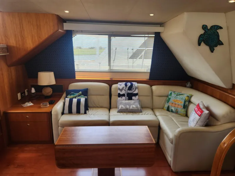 Slide: The Image of Interior of 2000 Silverton 453 Motor Yacht with cozy seating and wooden cabinetry. - 40