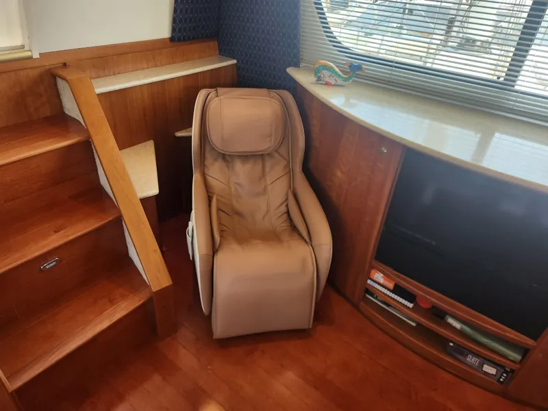 Slide: The Image of Interior of 2000 Silverton 453 Motor Yacht with wooden cabinetry and cozy seating area. - 42