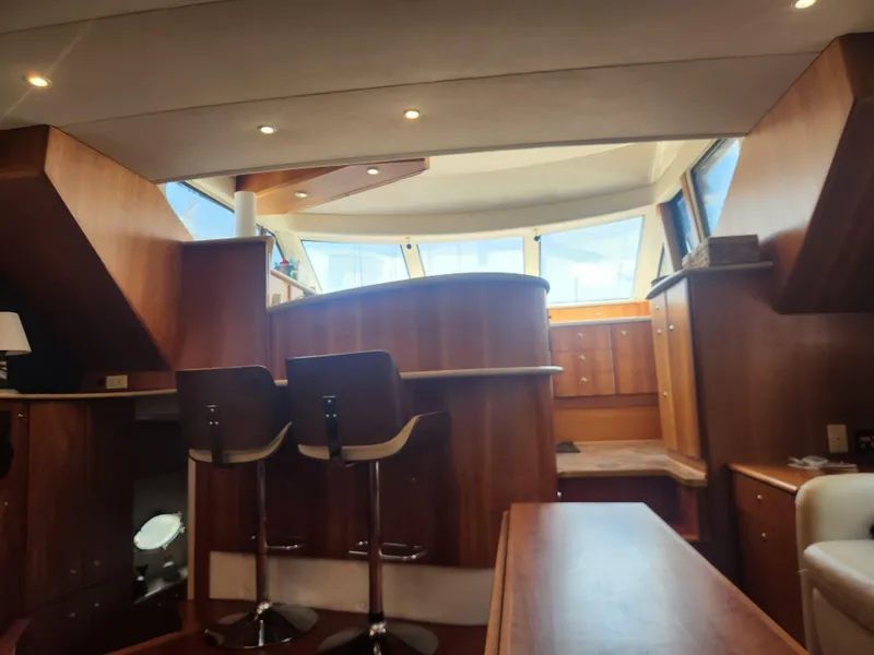 Slide: The Image of Interior of 2000 Silverton 453 Motor Yacht with modern kitchen and wooden cabinetry. - 46