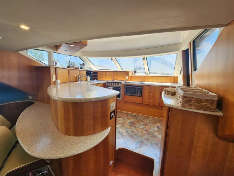 Slide: The Image of Interior of 2000 Silverton 453 Motor Yacht with modern kitchen and seating area. - 48