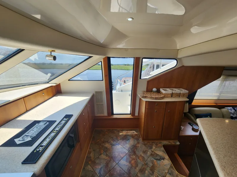 Slide: The Image of Interior of 2000 Silverton 453 Motor Yacht with modern kitchen and wooden cabinetry. - 49