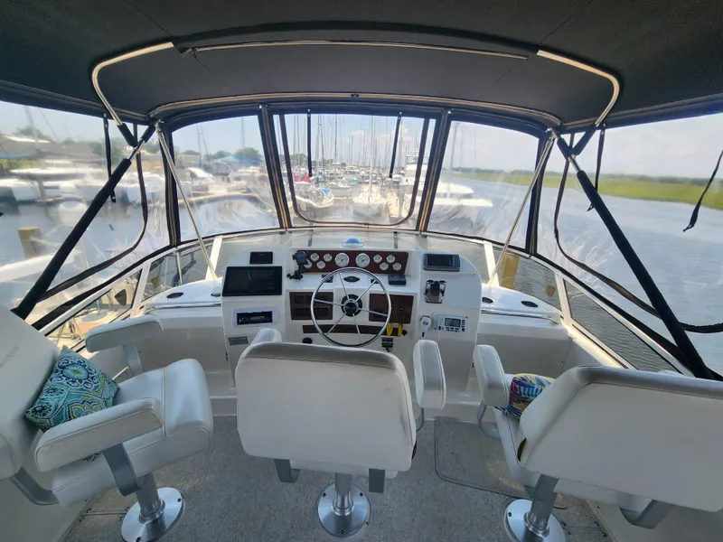Slide: The Image of Interior view of 2000 Silverton 453 Motor Yacht helm with steering wheel and seating. - 5